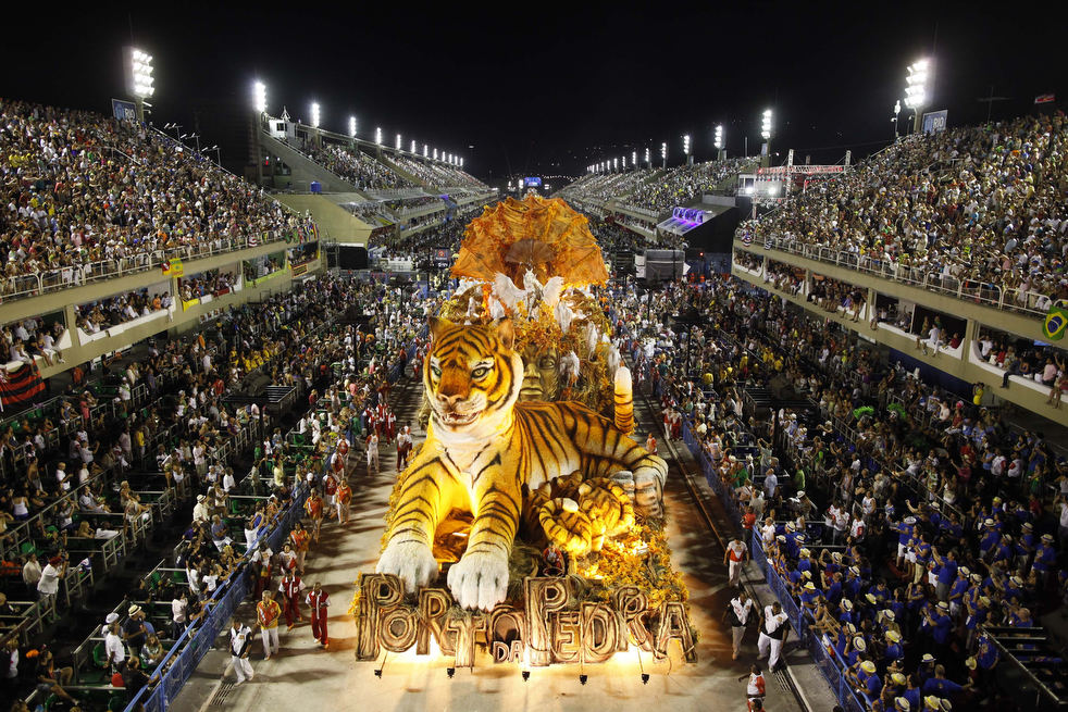 Dancers of Porto da Pedra samba school parade on a float during carnival celebrations at the Sambadrome in Rio de Janeiro, Brazil, Monday Feb. 20, 2012. (AP Photo/Felipe Dana)